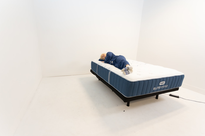 A person side sleeping on a Bear Elite Hybrid mattress