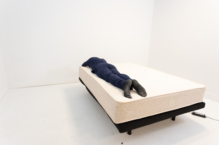 A man lying on his stomach on the Birch Natural mattress.