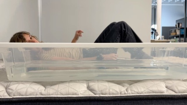 Our tester performs a ripple test on a Helix Midnight Luxe Mattress