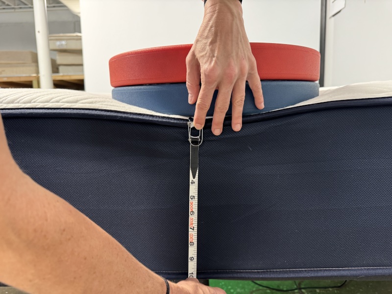 Measuring weight plates on the edge of a Big Fig Classic Mattress