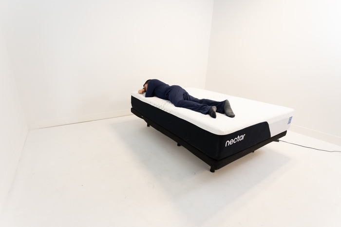A man stomach sleeping on the Nectar mattress.