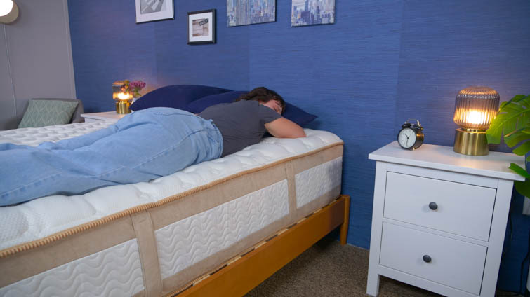 A person stomach sleeping on the Saatva Rx.