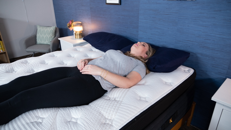 A woman back-sleeping on a Nolah Evolution mattress