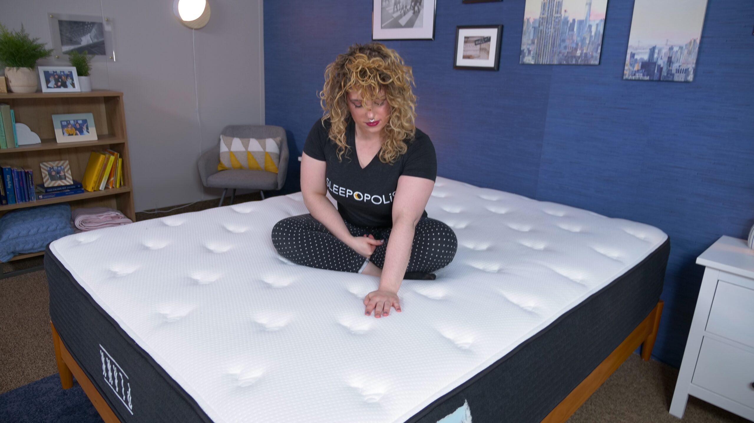 Nichole feeling the cover of the extra-firm side on the Plank Firm Luxe Construction