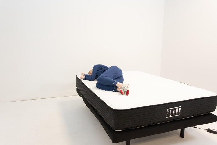 A woman lying on the Plank Firm in the side-sleeping position.