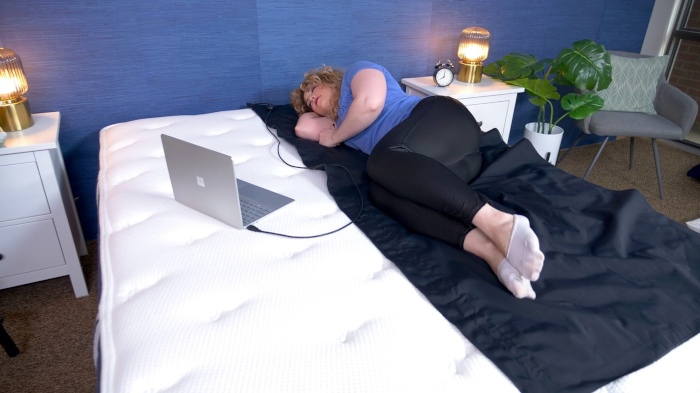 A person side sleeping on a Brooklyn Signature Hybrid mattress.