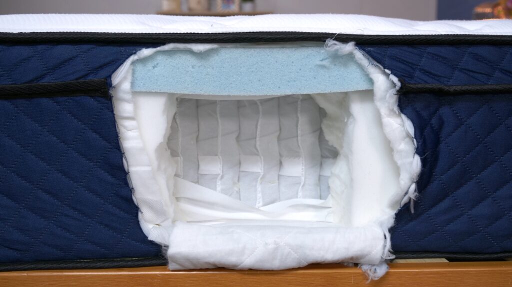 A cut-open mattress shows the interior construction of a Silk and Snow Hybrid mattress.
