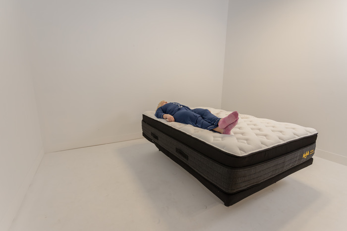 A woman lying on the Nolah Evolution mattress in the back-sleeping position.