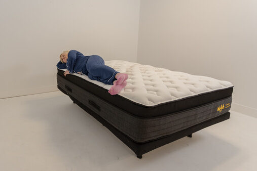 A woman lying on the Nolah Evolution mattress in the side-sleeping position.