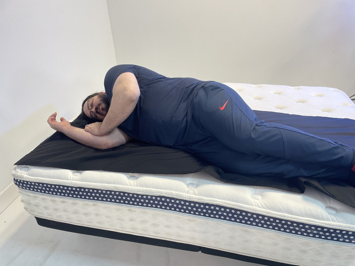 A man lying on the WinkBed on his side.